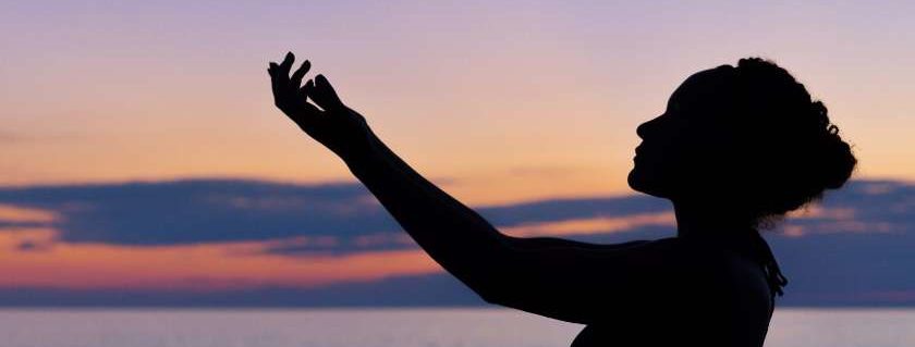 silhouette of woman raising hands and god did not give us a spirit of fear