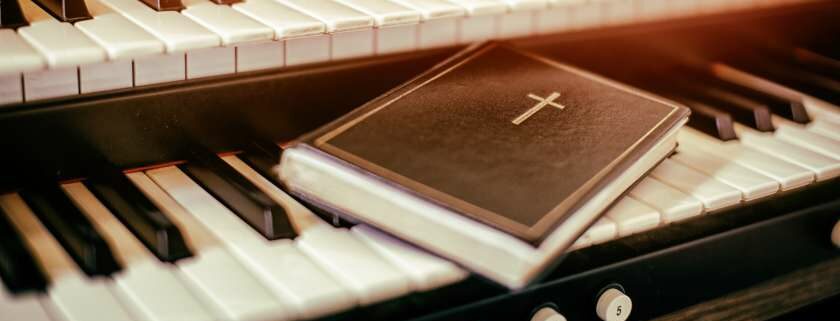 bible with a cross on a piano and revelation meaning in bible