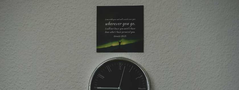 black and green wall clock with scripture above and list of the promises of god