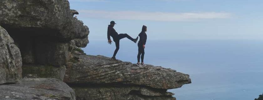 man about to kick woman off the cliff and did god create evil