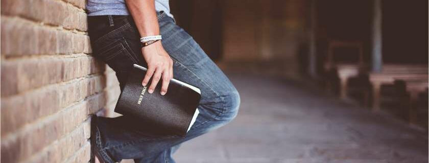 man against the wall holding bible intimacy with god