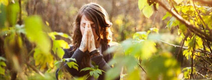 woman praying in the forest and god gives grace to the humble