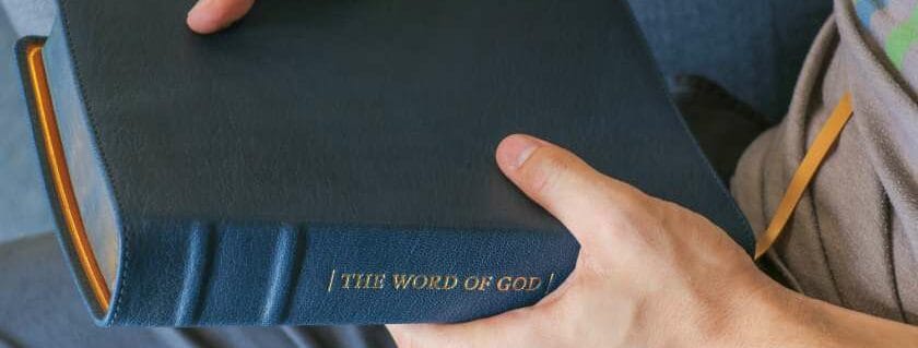 person holidng the word of god blue bible and bible verses about the word of god