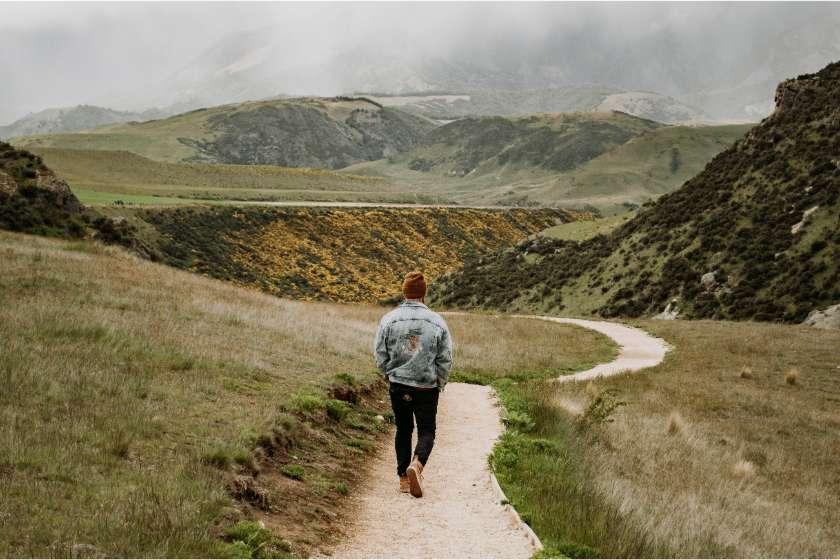 man walking with mountain view and god rewards those who diligently seek him