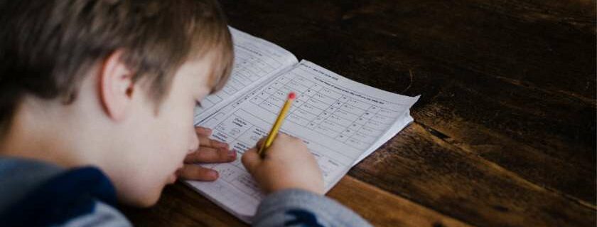boy writing and best christian homeschool curriculum