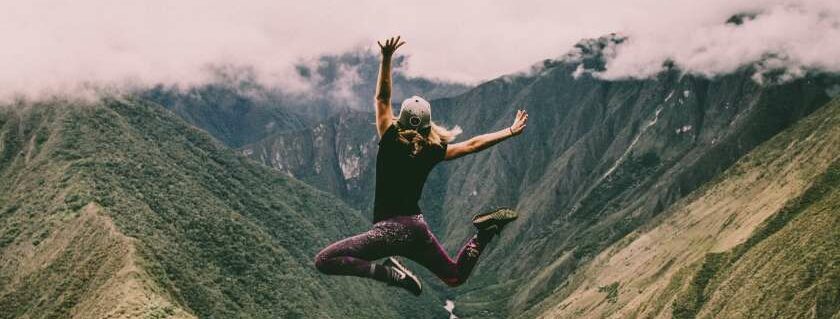 girl jumping on mountain