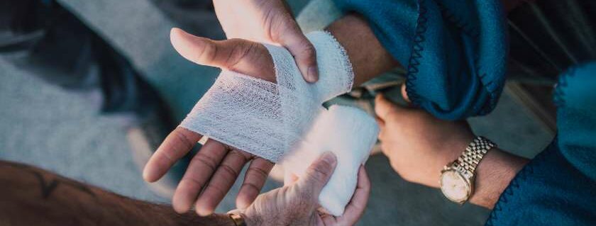 wrapping a bandage around a right hand