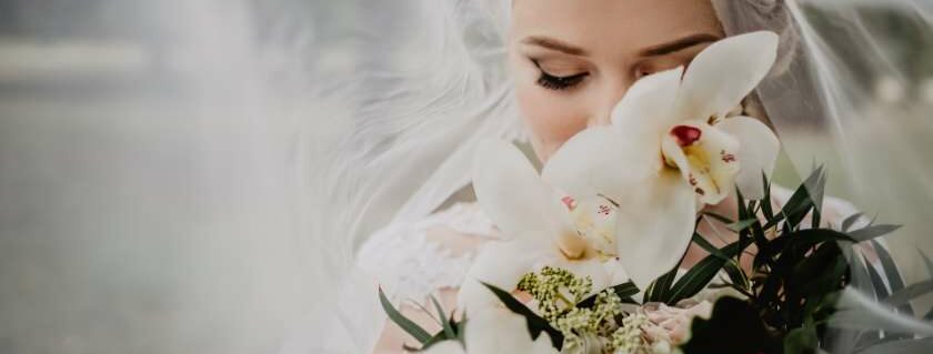 bride holding bouquet of white flowers and bride of christ