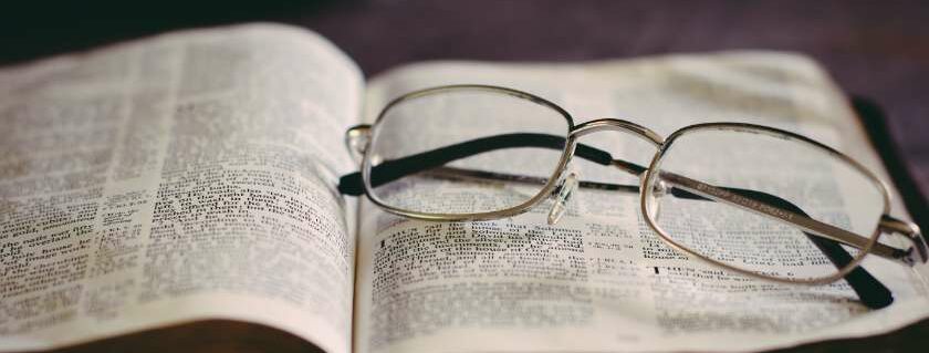 open bible with eyeglasses