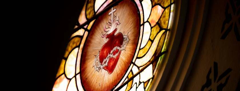 stained glass image of thorns around heart