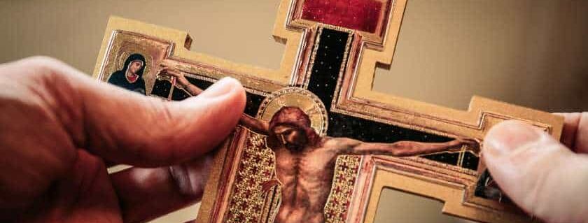 person holding an ornate crucifix