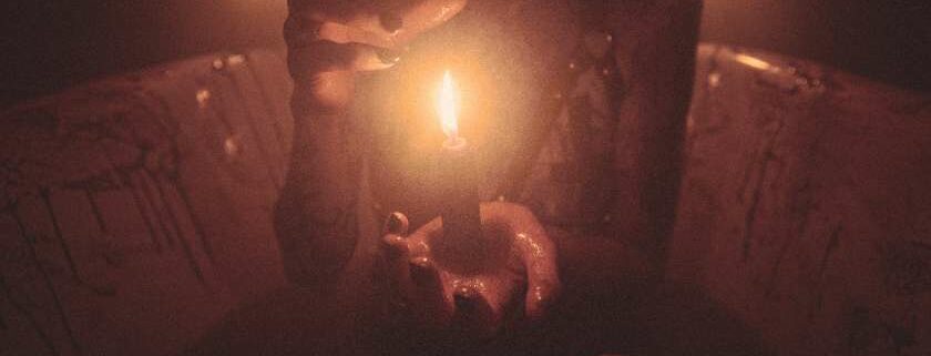 woman holding candle in the dark