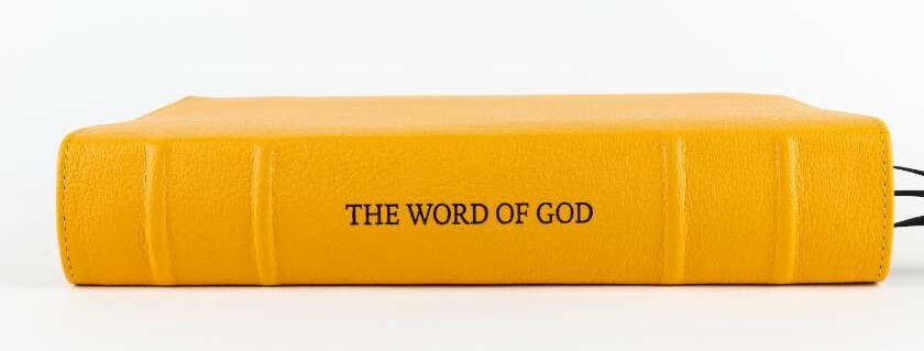 yellow bible with word of god label