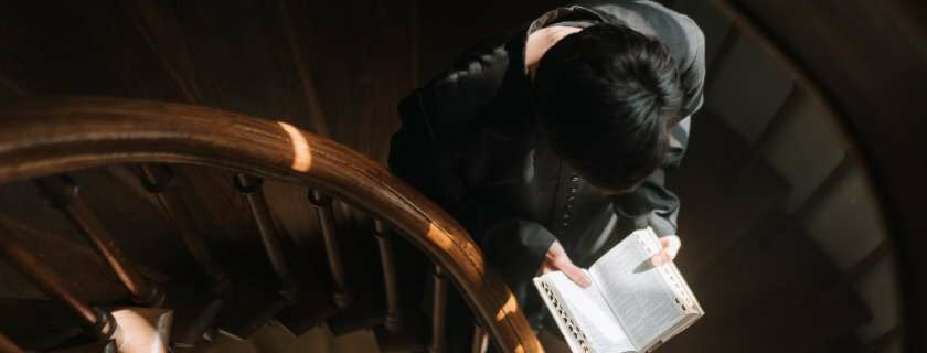 a person walking down the stairs with a Bible
